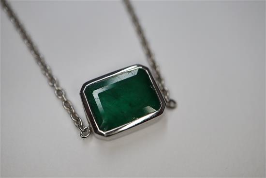 An 18ct white gold and solitaire emerald set pendant necklace, pendant 9mm.